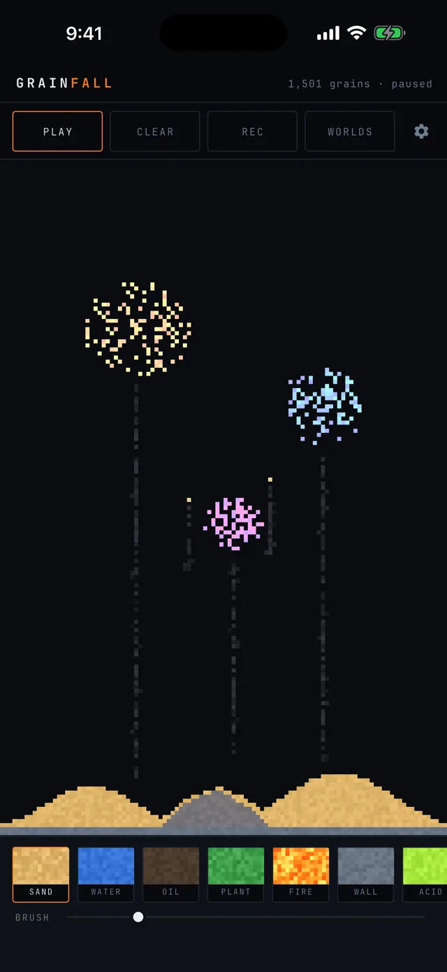 Three firework bursts in gold, blue, and violet over dunes at night